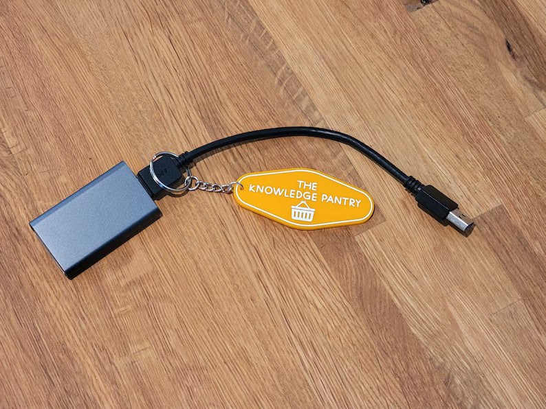 The Knowledge Pantry Lite Portable Hard Drive with Orange The Knowledge Pantry Key Chain and USB Cable.
